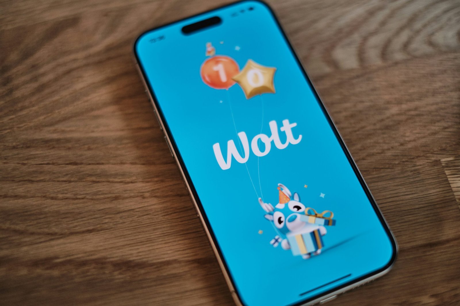 A phone with the word woot on it sitting on a table